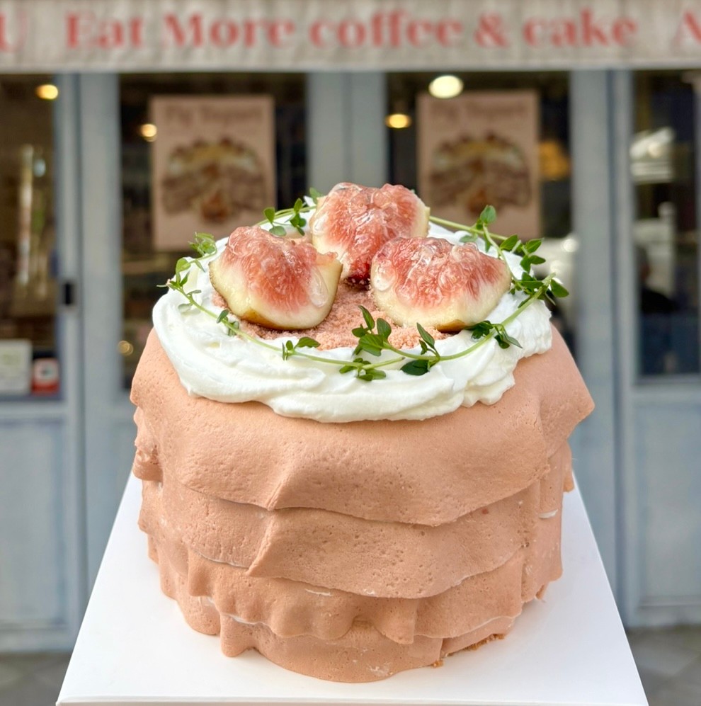 Peach colored fig cream cake outside studio entrance