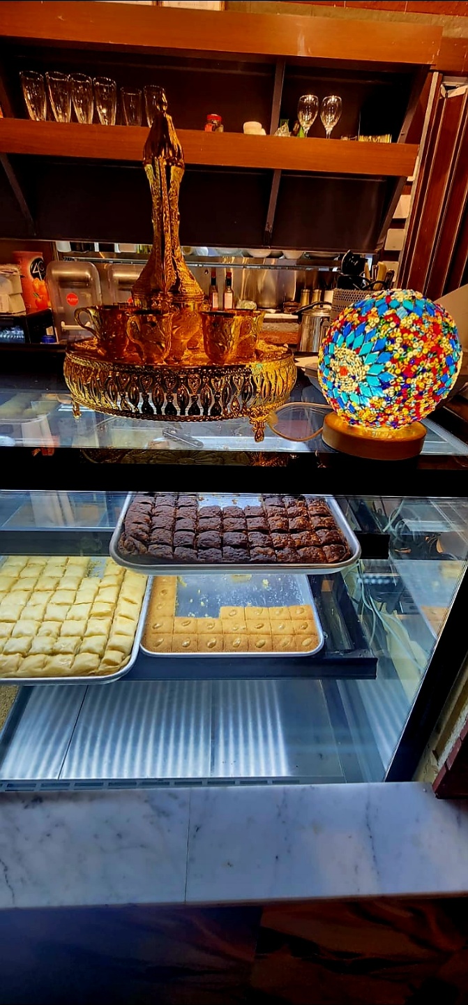 Traditional ornate golden serving set and baklava dessert case