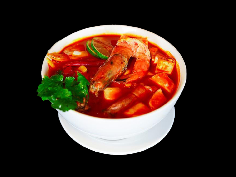 Aromatic Tom Yum Goong soup with whole prawn, galangal, lemongrass, and lime