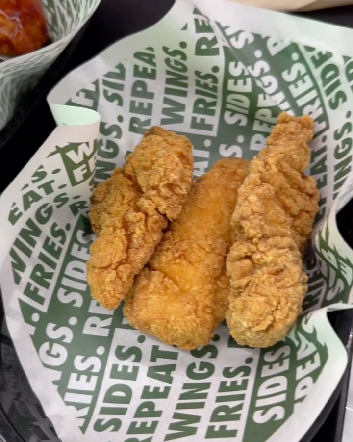 Golden-brown crispy chicken tenders in a Wingstop serving basket