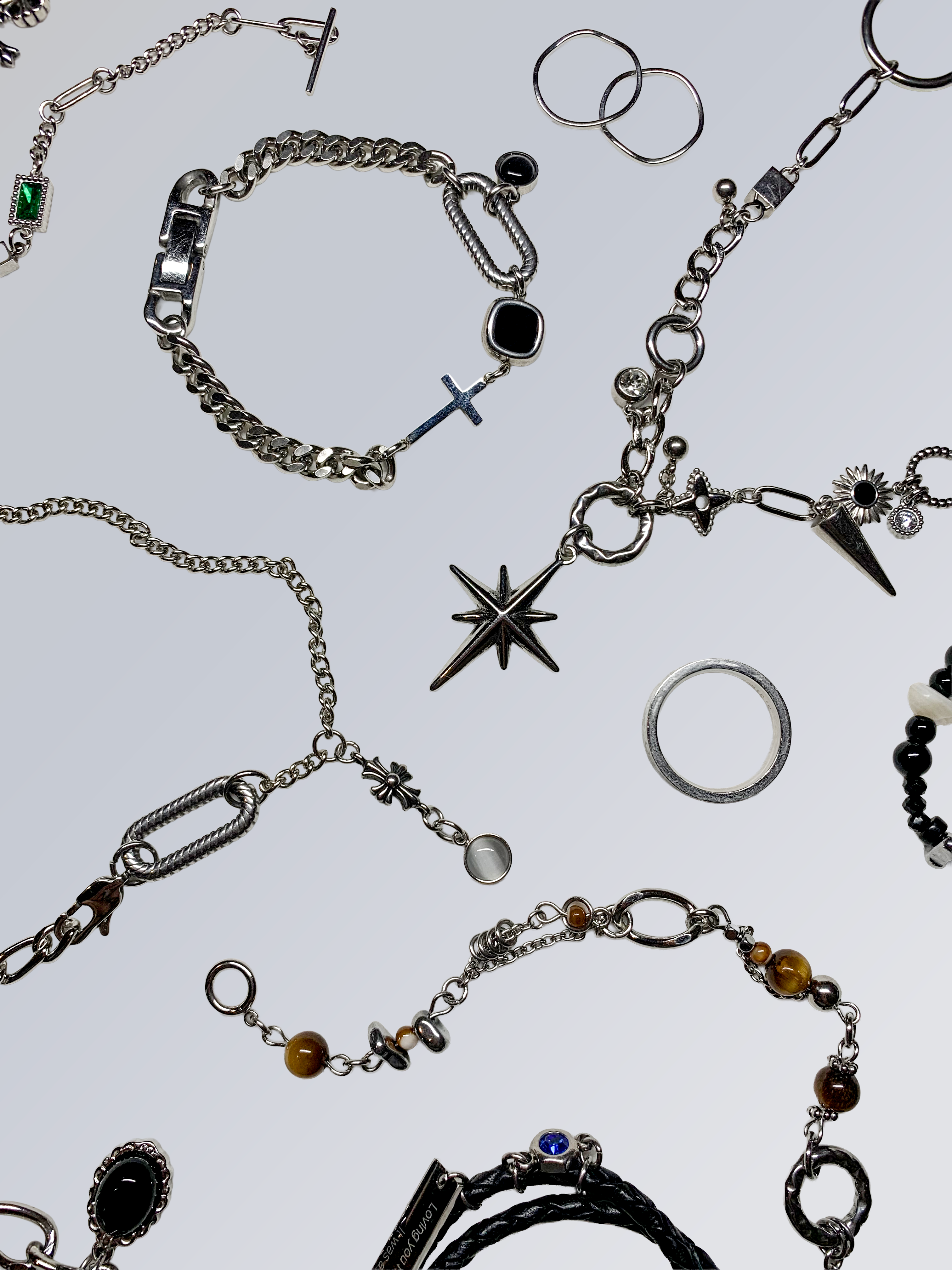 Silver chains, links and clasps arranged on a light surface