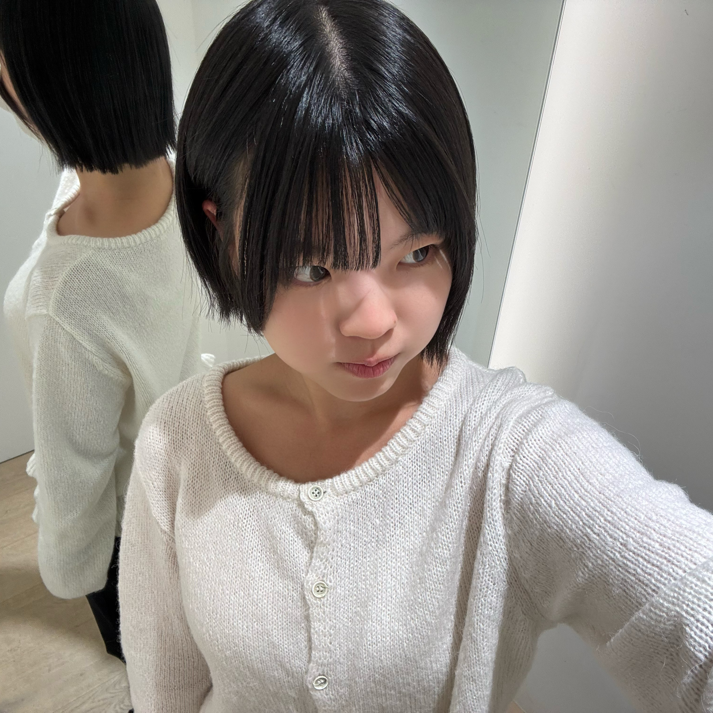 A fresh short bob style showcasing clean cut lines and straight bangs.