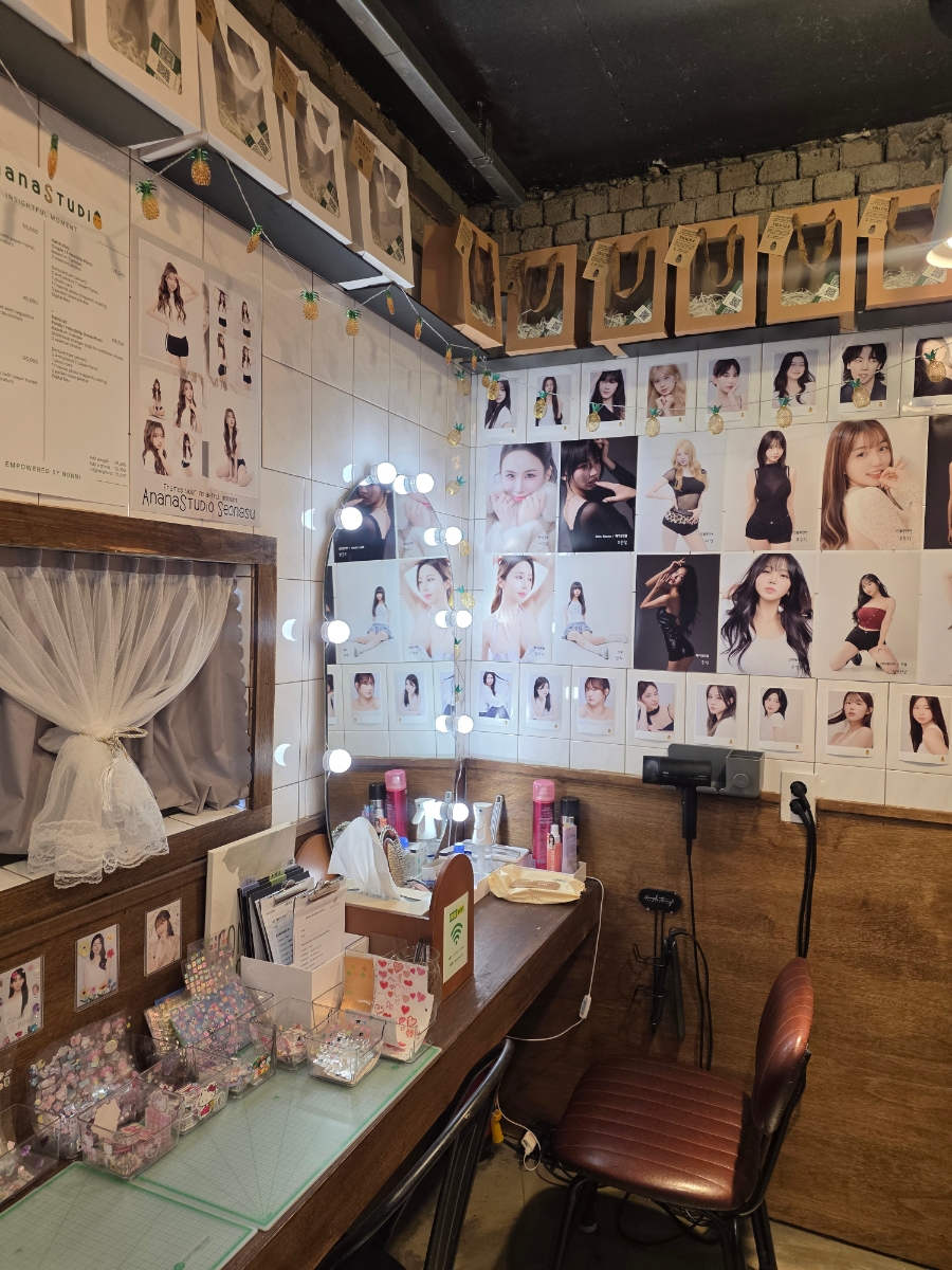 Anana Studio brightly lit vanity station with hair styling tools and tiled mirror wall