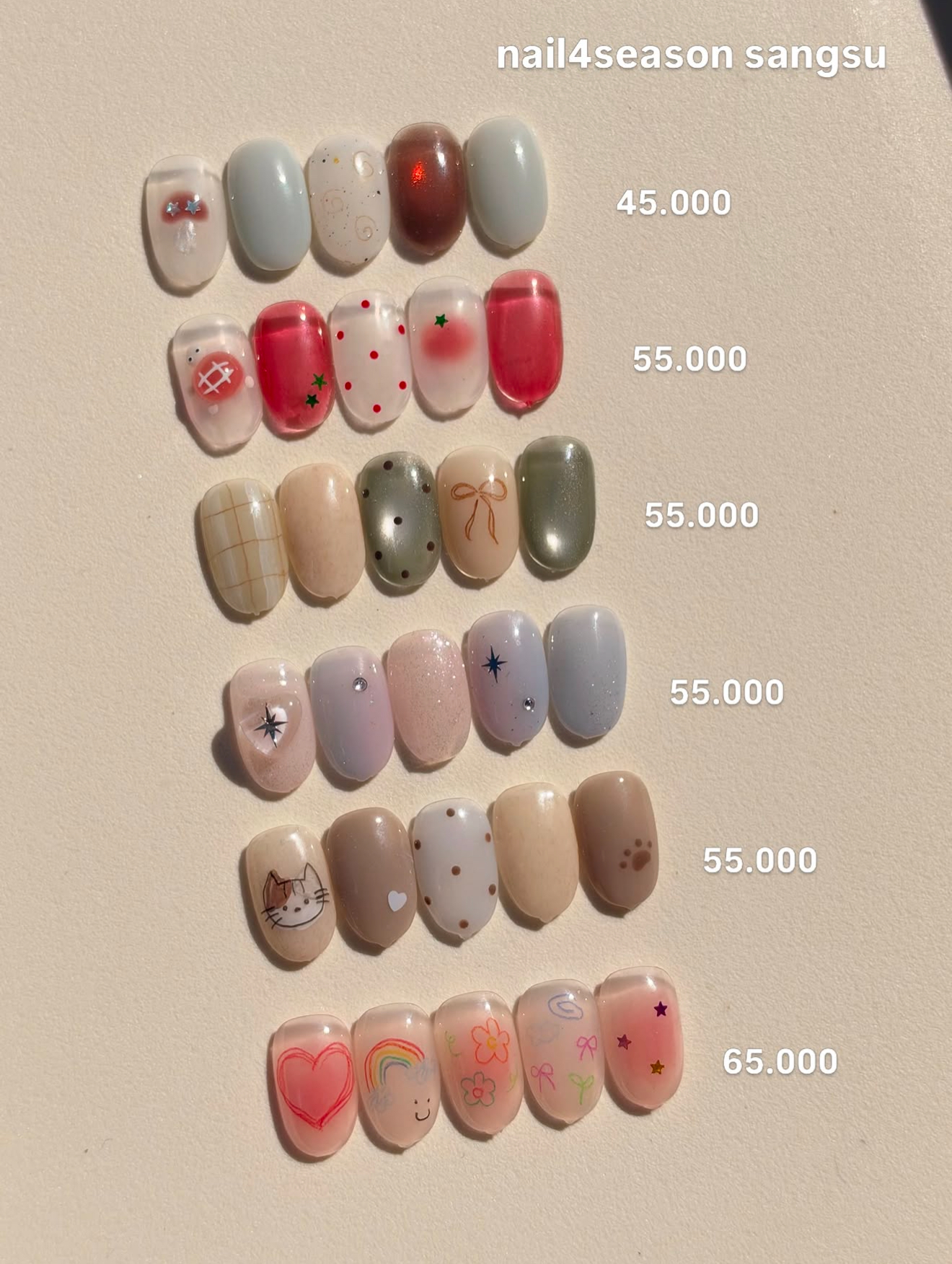 Showcase display board of custom nail art sample designs organized by style
