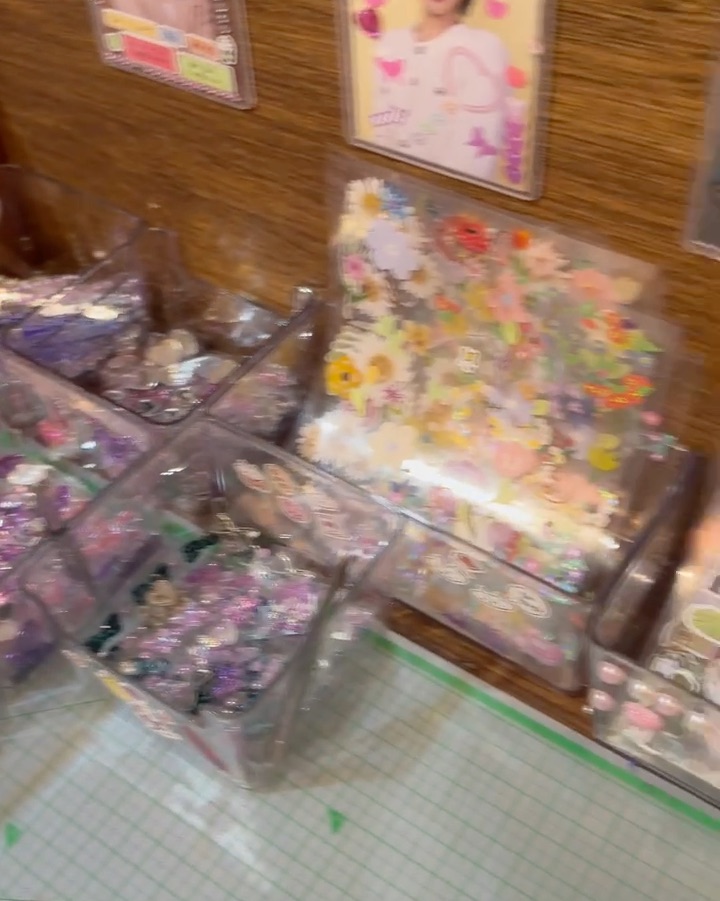 Clear bins containing decorative stickers and craft supplies in the waiting lounge