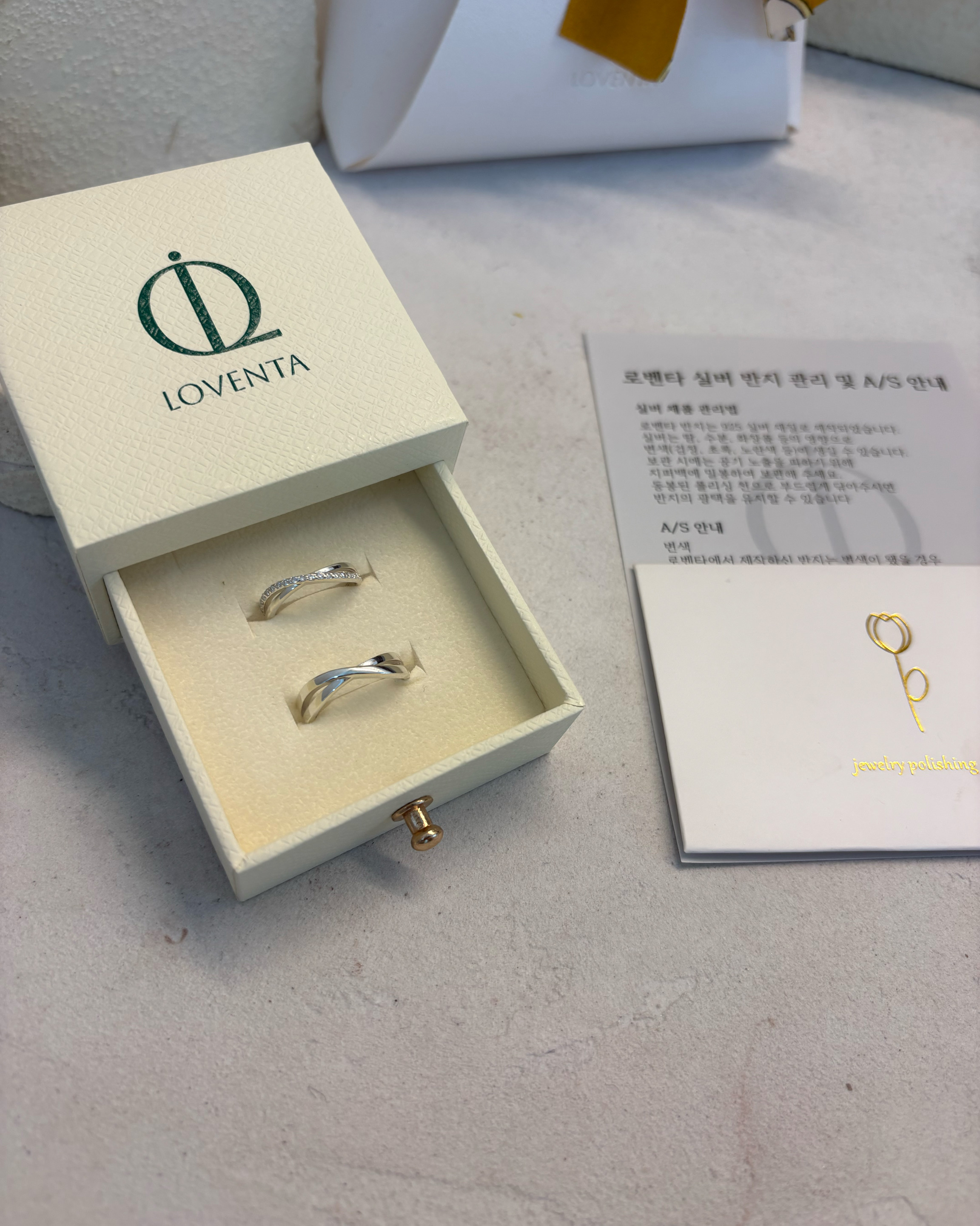 LOVENTA branded ring box and gift bag tied with patterned silk ribbon