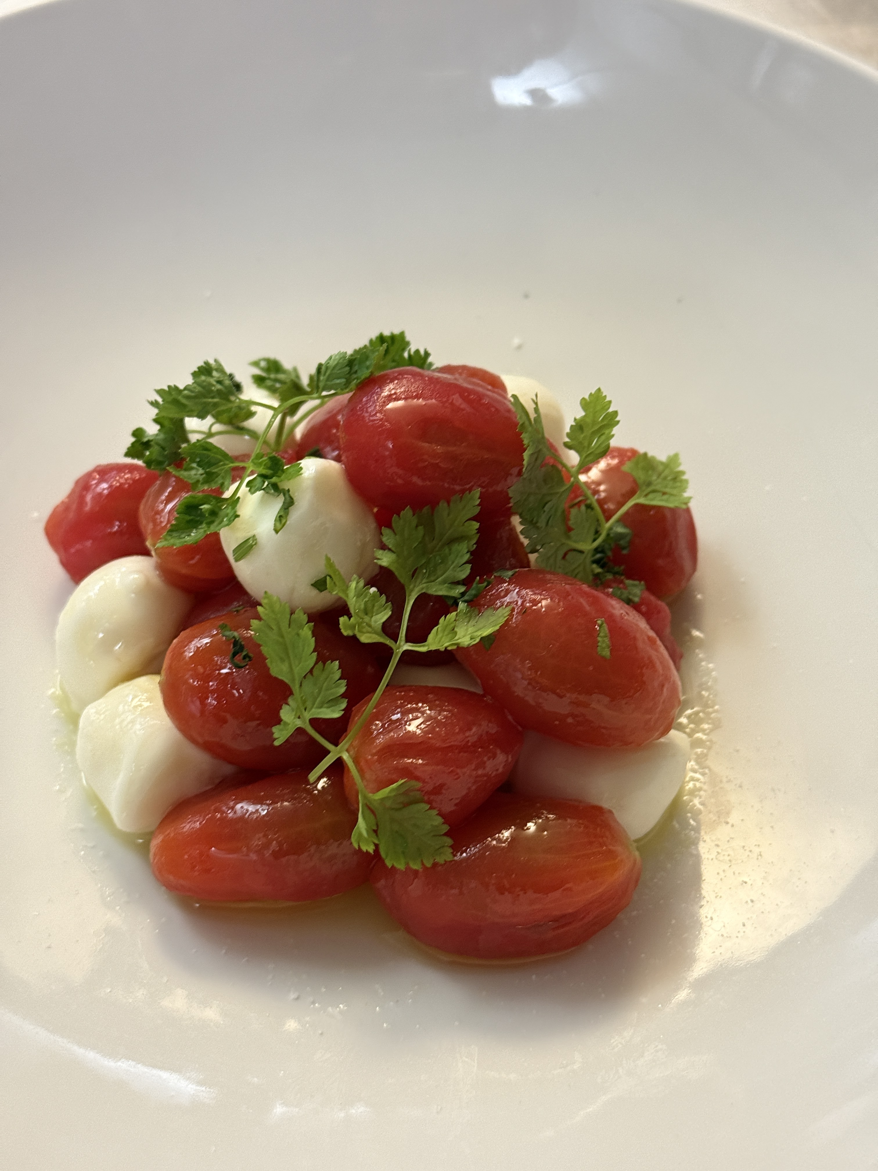 Fresh Caprese salad with bright cherry tomatoes and bocconcini mozzarella