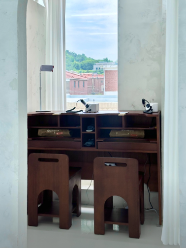 Wooden workbench beside the studio window