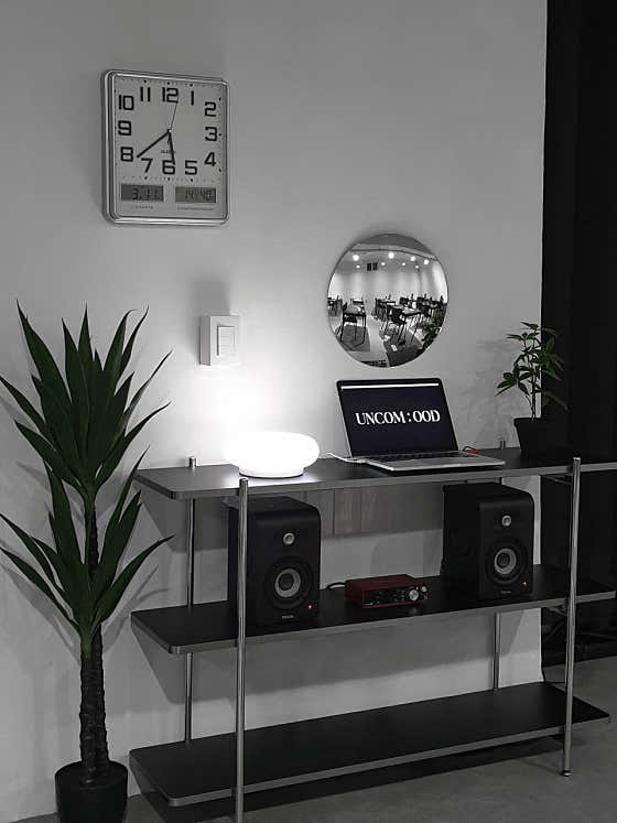 UNCOMOOD Seongsu console with a plant, mirror, lamp and studio wordmark