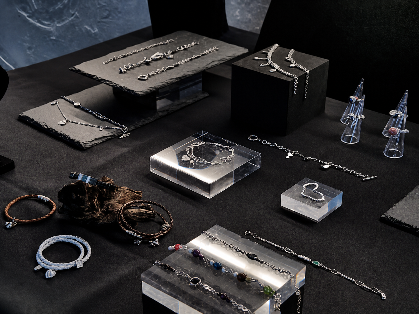 Silver jewelry arranged on display blocks at UNCOMOOD