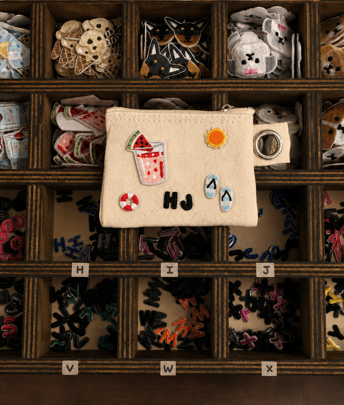 Art-directed catalog photograph of a pouch decorated with embroidered patches at Yeoul