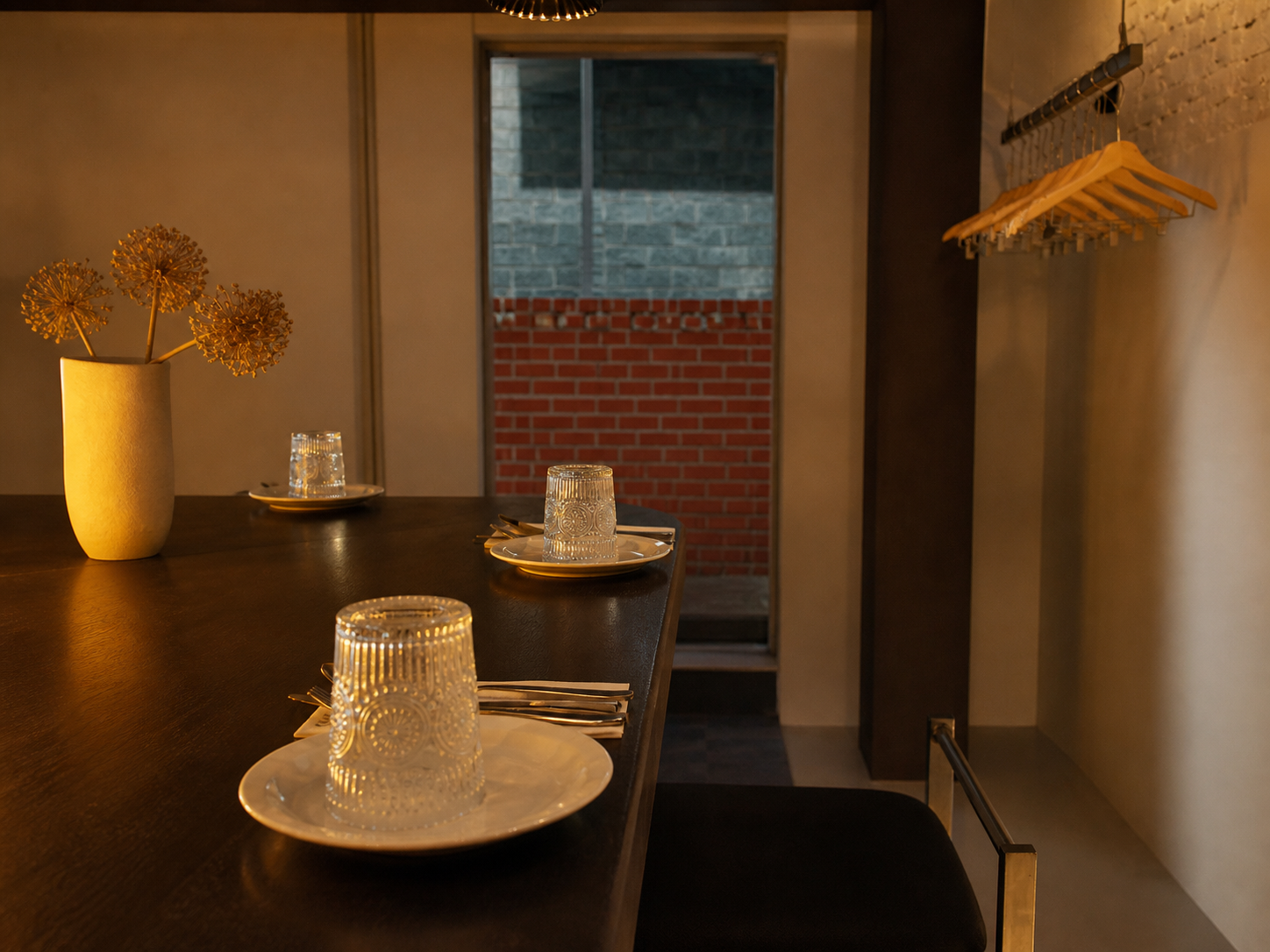 Warm counter seating and place settings inside KKIK Seoul