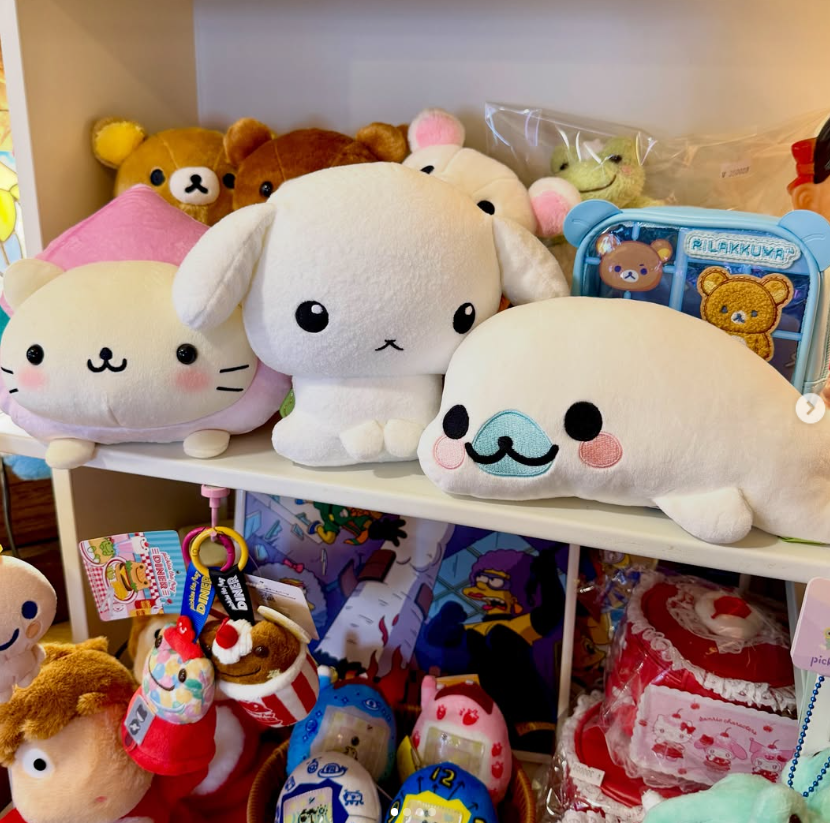 Character plush toys arranged on a white shelf