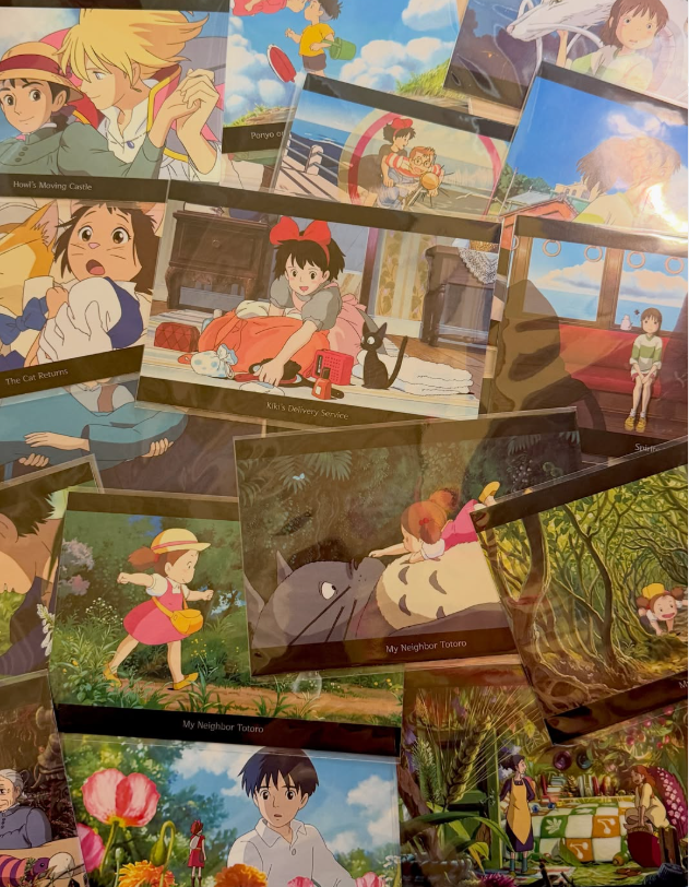 Studio Ghibli film postcards spread across a table