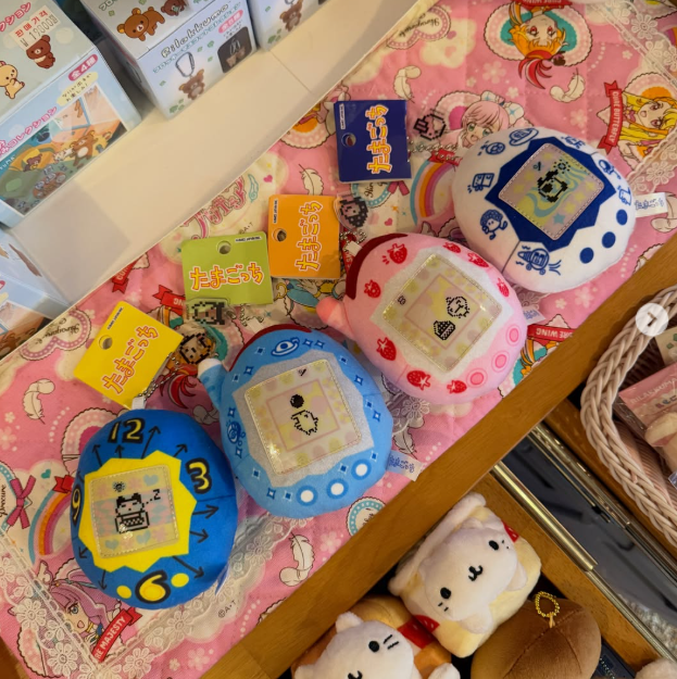 Vintage Tamagotchi toys on a pink patterned display