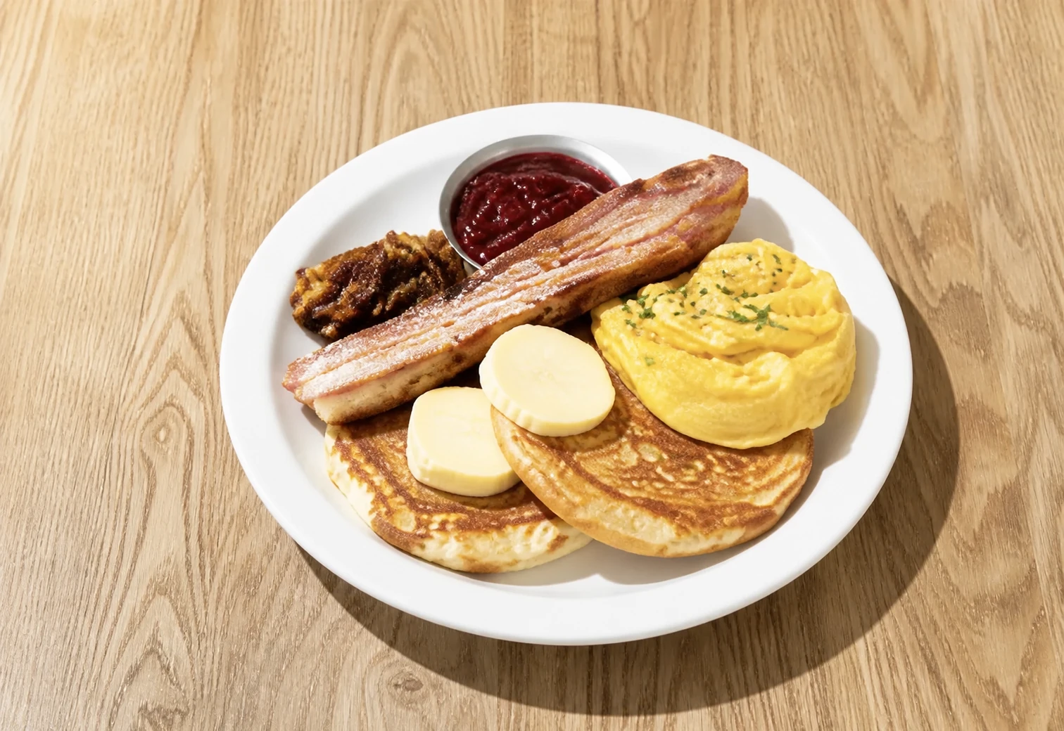 Ricotta pancakes with bacon, butter, and syrup